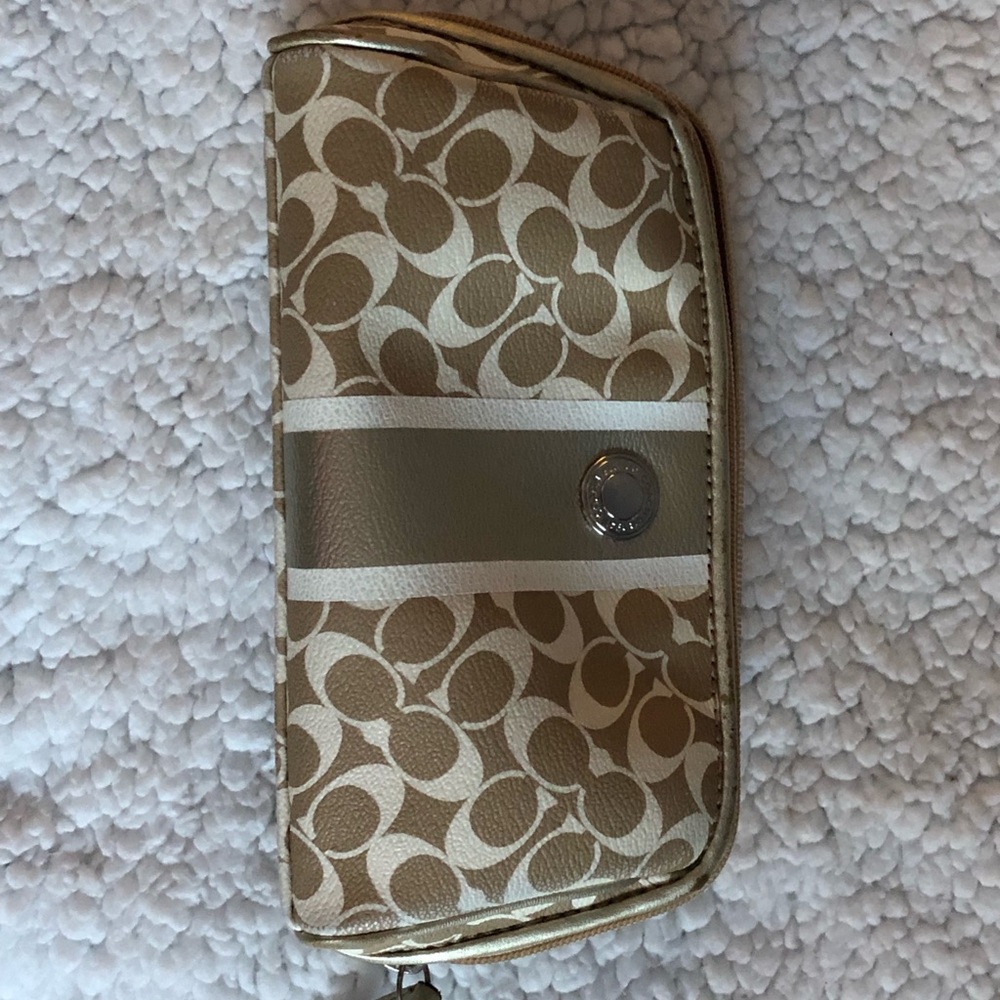 Gently used gold Coach cosmetic bag